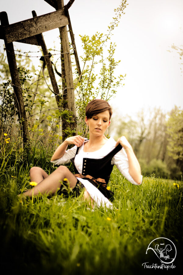Girl undresses Bavarian custom dress