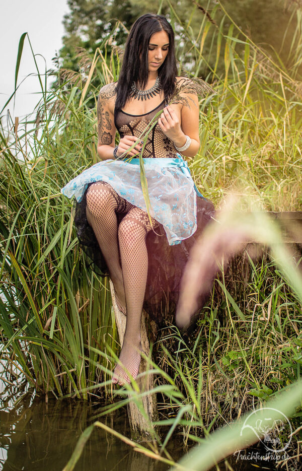 Beautiful dark-haired girl in bodystocking and dirndl